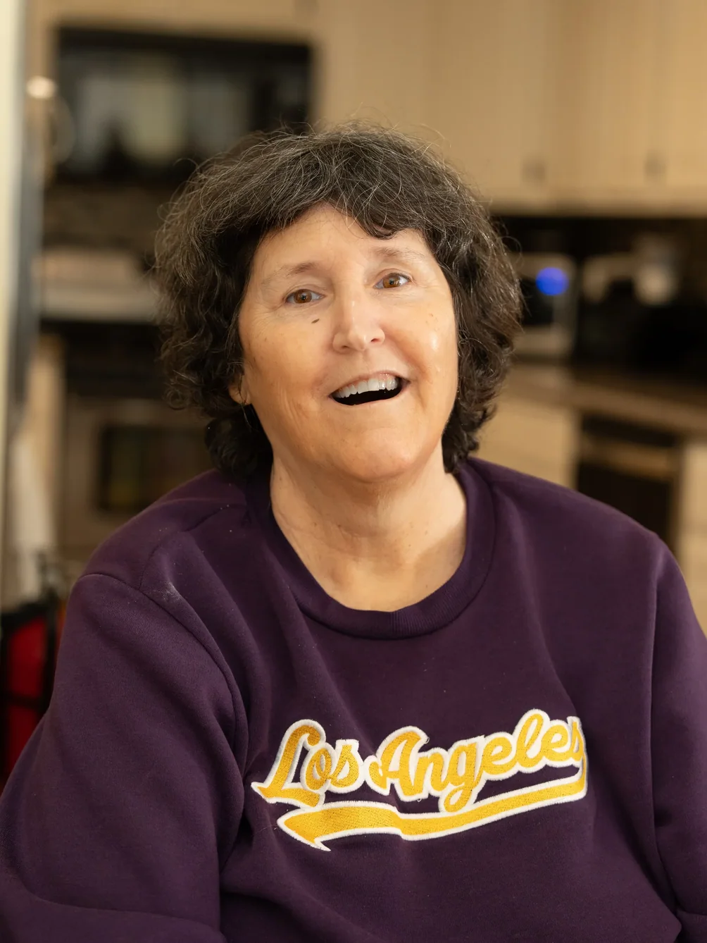 Happy resident smiling warmly at camera in comfortable home environment